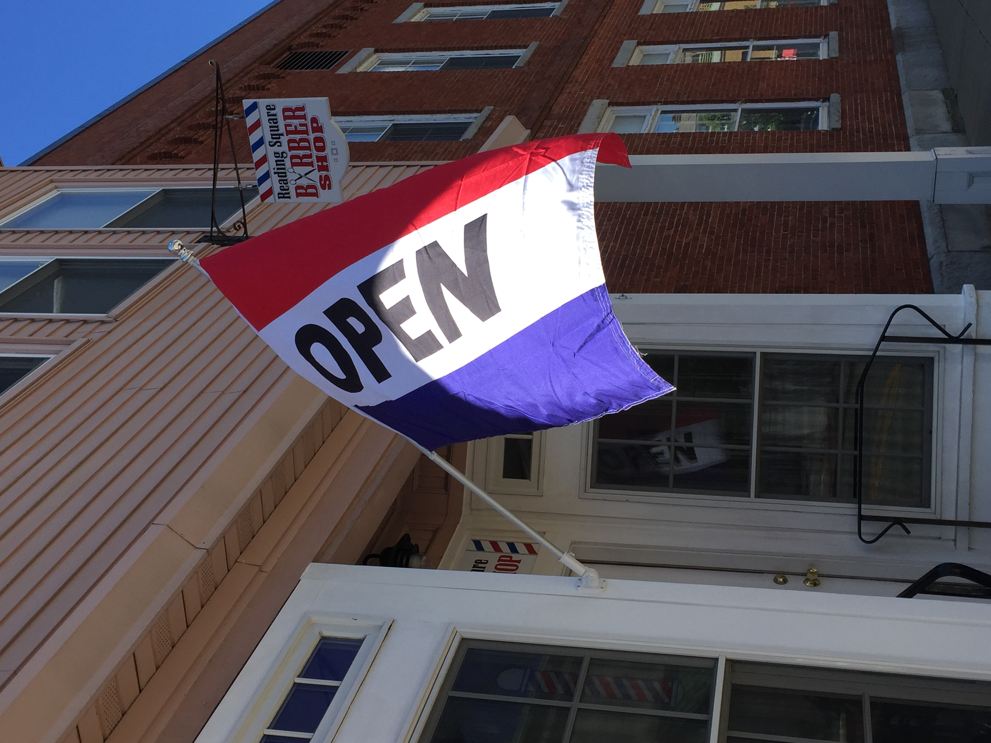 Open flag outside barbershop